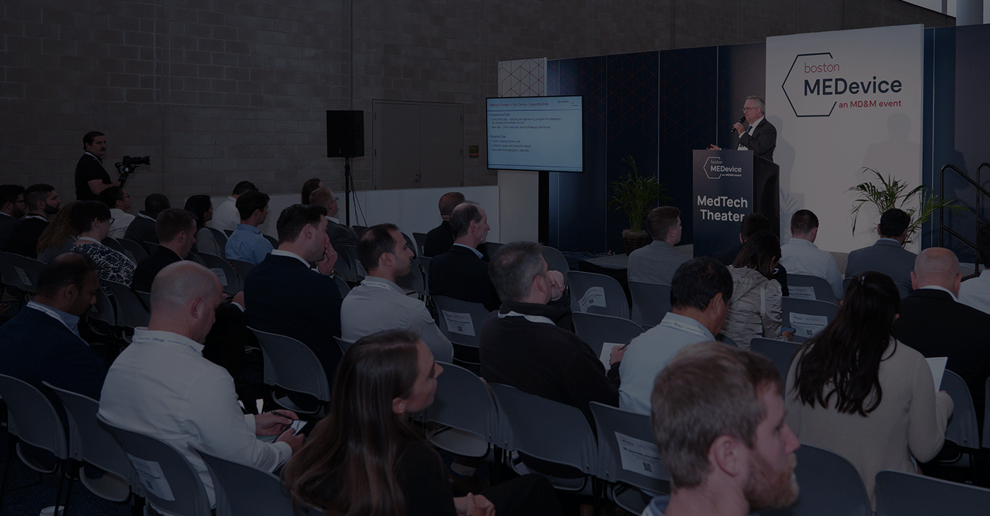 A conference speaker presenting in front a delegates