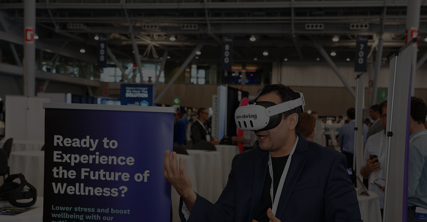 A man trying virtual reality glasses in a crowded expo hall